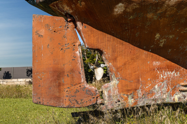 The battered rudder of landlocked ship